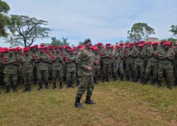Gen. Kavuma while chanting with military Police officers