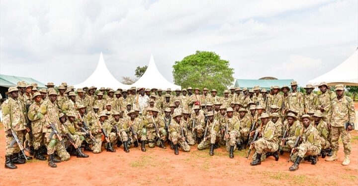 UPDF solidiers pose for a photo after completing their Tier II Course at Fort Samora Machel Special Forces School in Kaweweta on Wednesday. (Seated C) is Col JB Asinguza, Director of Training in SFC