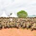 UPDF solidiers pose for a photo after completing their Tier II Course at Fort Samora Machel Special Forces School in Kaweweta on Wednesday. (Seated C) is Col JB Asinguza, Director of Training in SFC
