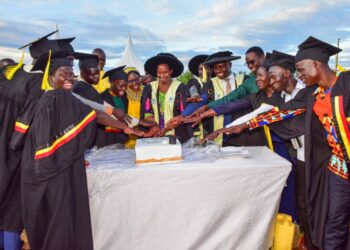 The State House Comptroller Jane Barekye (center) cutting the cake with graduates, local leaders and teachers at the 1st graduation of the Presidential Initiative for Zonal Industrial Parks for Skills Development, Value Addition and Wealth creation at the Lango Zonal Industrial Hub in Lira district on 3rd January 2023. Photo by PPU / Tony Rujuta.