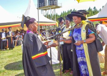 The State House Comptroller Jane Barekye (right) giving certificates to the best graduates during the First Cohort graduation ceremony at the Bunyoro Industrial Hub in Myeeba Nyakaronga Village, Kimengo Sub-county, Masindi District on 5th January 2022. Photo by PPU/ Tony Rujuta.