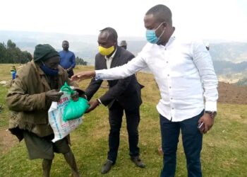 Hon. Kamuntu Gives Packed Maize Floor, beans and Soap to Mutwa at Rwamahano Village