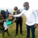 Hon. Kamuntu Gives Packed Maize Floor, beans and Soap to Mutwa at Rwamahano Village