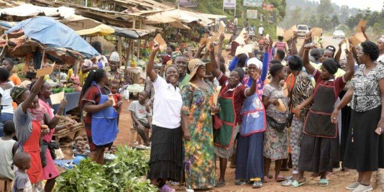 Some of the market women express their excitement after receiving financial support from President Yoweri Museveni