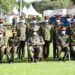 President Yoweri Museveni in a group photo with the NDC-U graduands