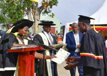 State House Comptroller Jane Barekye (R) hands over a certificate to one of the best students at the Mengo Zonal Industrial Hub in Kayunga during a graduation ceremony on Thursday. PPU Photo