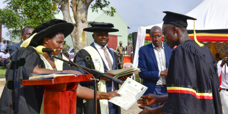 State House Comptroller Jane Barekye (R) hands over a certificate to one of the best students at the Mengo Zonal Industrial Hub in Kayunga during a graduation ceremony on Thursday. PPU Photo