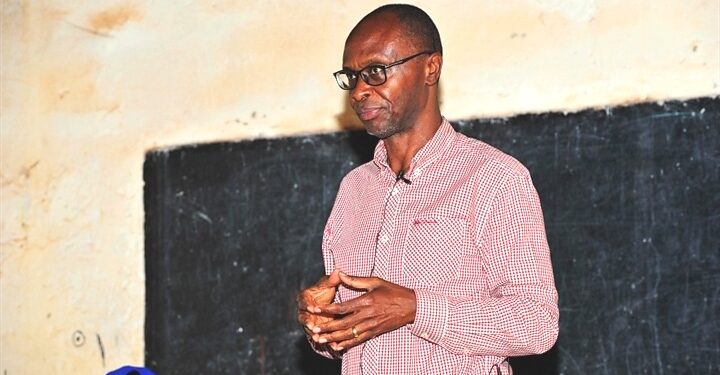 Mr. Moses Byaruhanga addressing small business owners in Kawempe Division