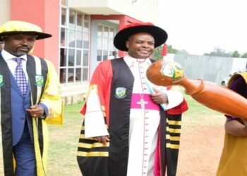 A student (right) leads the Deputy Speaker, Hon. Thomas Tayebwa (left) and the Chancellor of the University of Saint Joseph, Mbarara City, His Grace, Lambert Bainomugisha, to the 2nd graduation ceremony on Saturday, 18 February 2023