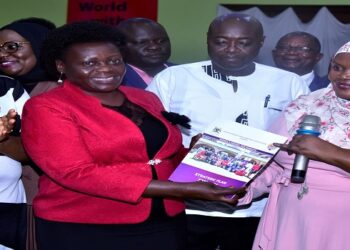 Nakadama (R) receives a copy of the UWOPA strategic plan from Opendi