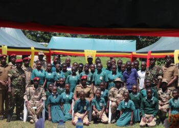 SFC leadership in a group photo with pupils and teachers of SFC Army Primary Schools