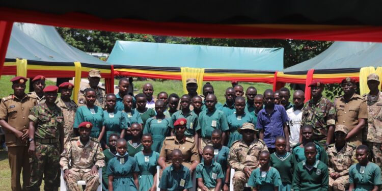 SFC leadership in a group photo with pupils and teachers of SFC Army Primary Schools