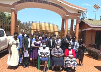 Minister Babalanda in a group photo with the Management of Jinja School of Nursing and Midwifery