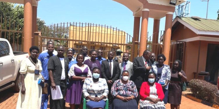 Minister Babalanda in a group photo with the Management of Jinja School of Nursing and Midwifery