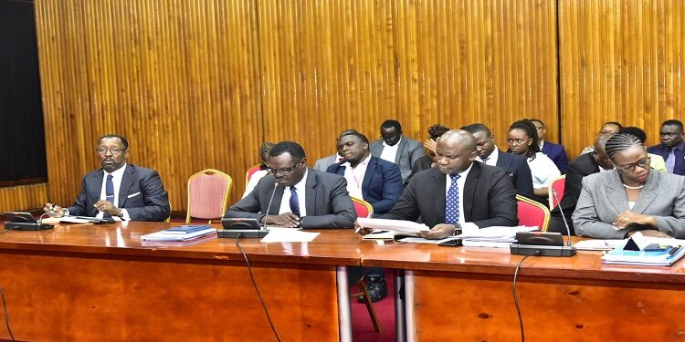 Former NSSF MD, Richard Byarugaba (L) appearing before the committee investigating the fund