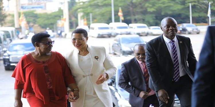 Speaker Anita Among (C) is welcomed by former Member of Parliament, Miria Matembe. On the Right is SACCO Chairperson, Hon. Robert Migadde