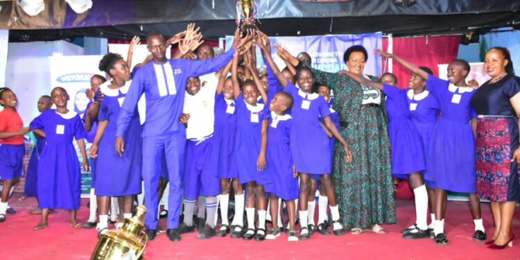 Nakivubo Blue Primary School celebrates with their head teacher and the Director Education and social service on the extreme right.