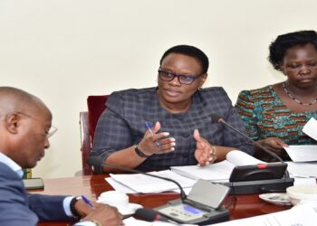 Hon. Nyakikongoro (C) chairing the committee where Kasingye (L) and other members of the Police Sacco leadership appeared