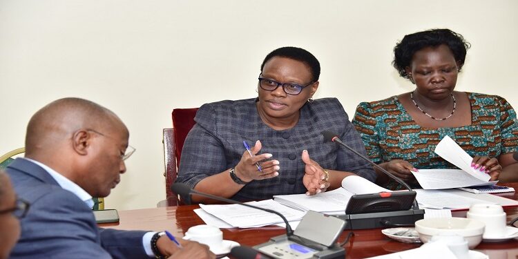 Hon. Nyakikongoro (C) chairing the committee where Kasingye (L) and other members of the Police Sacco leadership appeared