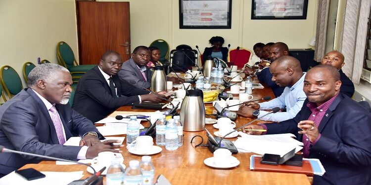 Former REA staff (R) appearing before the committee. One the left is Hon, Eddie Kwizera