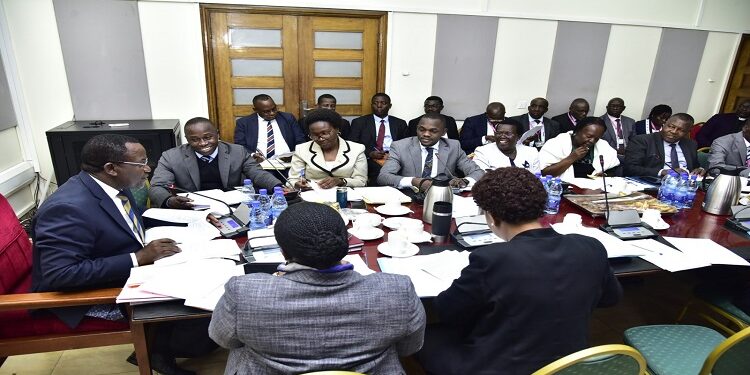Hon. Peter Ogwang (2nd L) appearing before the committee chaired by Hon. Twesigye (L)