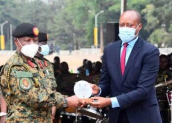 Mbarara City North MP Robert Rukaari receives a plaque from the Chief of Defence Forces at the recent Tarehe Sita celebrations in Mbarara. The UPDF recognised Rukaari for organising the celebrations on February 4.