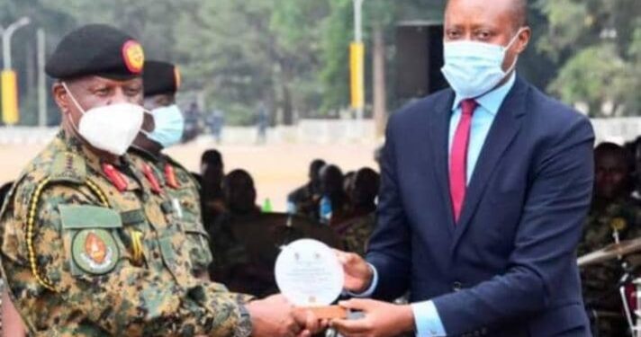 Mbarara City North MP Robert Rukaari receives a plaque from the Chief of Defence Forces at the recent Tarehe Sita celebrations in Mbarara. The UPDF recognised Rukaari for organising the celebrations on February 4.