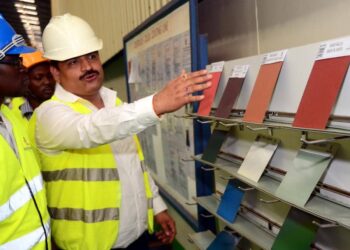 A Roofings Group official takes visitors through some of the eco friendly products the company has on offer recently during a tour of the company's premises
