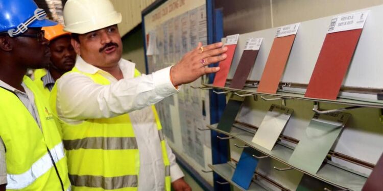 A Roofings Group official takes visitors through some of the eco friendly products the company has on offer recently during a tour of the company's premises