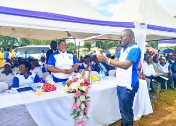 Minister Babalanda handing over President Museveni's and her contributions towards the construction of Iganga SS Science block