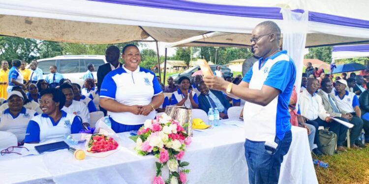 Minister Babalanda handing over President Museveni's and her contributions towards the construction of Iganga SS Science block