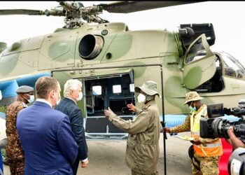 President Museveni chats with Valari Copcin after commissioning into flight the first Soviet Union-Russian type helicopter overhauled in Africa by Pro Heli International Services at Nakasongola. PPU Photo