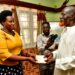 Mrs. Barekye handing over President Museveni's condolence message to the father of Isma Olaxess