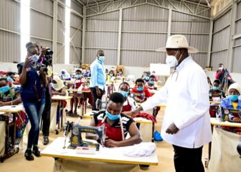 President Museveni interacts with tailoring students at Masaka regional industrial hub shortly after  commissioning the youths skilling  facility in Masaka on Wednesday