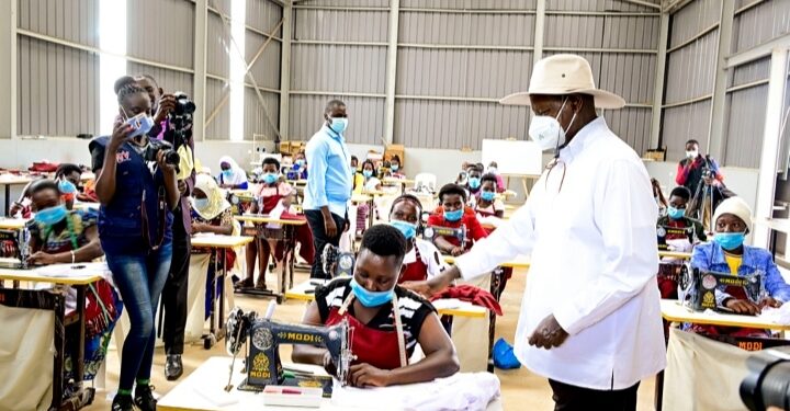 President Museveni interacts with tailoring students at Masaka regional industrial hub shortly after  commissioning the youths skilling  facility in Masaka on Wednesday