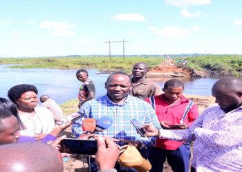 Hon. Mpuuga (c) speaking to journalists along the Villa-Maria, Kyamulibwa-Kabulasoke Road where another bridge was washed away