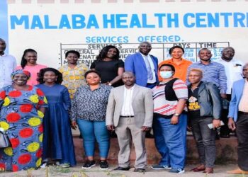 Hon. Kayagi (front row, 5th left) with committee members and stakeholders following a tour of Malaba Health Centre IV