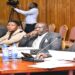 Birungi (R) with colleagues from the financing body appearing before the committee