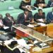 The LOP, Hon. Mpuuga stands on a point of procedure as Hon. Pacutho (satnding on the right) presents amendments to the bill
