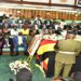 Premier Nabbanja pays her respects after laying a wreath on the coffin containing the body of Engola