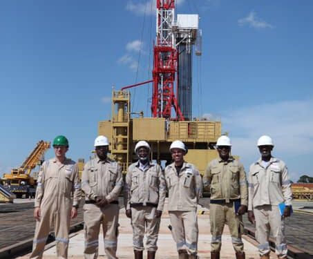 Earnest Rubondo (second right) poses for a photo with technicians and engineers on his arrival at the Jobi-Rii field, Tilenga Project on June, 7th 2023 (Photo @PAU)