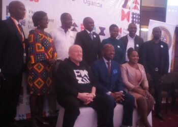 Minister of State for Finance, Amos Lugoloobi (Seated Centre) is flanked by PMI officials at Kampala Sheraton Hotel on Thursday