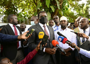 PPS Kenneth Omona speaks to the press at the State House gate in Nakasero where he received a banner from the people with messages wishing President Museveni a quick recovery. PPU Photo (1)