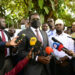 PPS Kenneth Omona speaks to the press at the State House gate in Nakasero where he received a banner from the people with messages wishing President Museveni a quick recovery. PPU Photo (1)