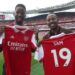 Adrian Ntwatwa winner of the Global Gooners competition, (M) poses for a picture with Sam Rugunda his friend (L) and Gilberto Silva) during the grand Emirates stadium tour, home of the Gooners. They were invited to watch the recent home game against Brighton & Hove Albion F.C.