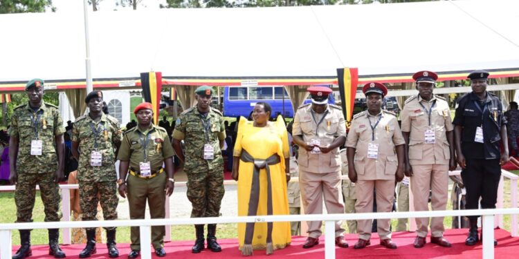 Some of the medalists pose for a photo with PM Nabanja after receiving their medals in Luwero on Friday. PPU Photo