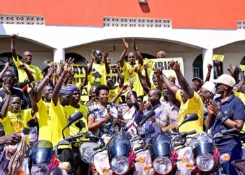 The State House Comptroller,  Ms. Jane Barekye handing over the boda bodas to the Nubian youths in Bombo