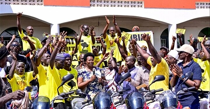 The State House Comptroller,  Ms. Jane Barekye handing over the boda bodas to the Nubian youths in Bombo