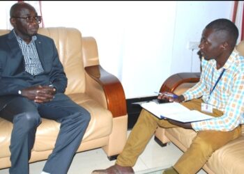 Journalist Brian Mugenyi (Right)