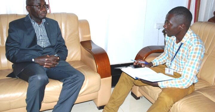 Journalist Brian Mugenyi (Right)